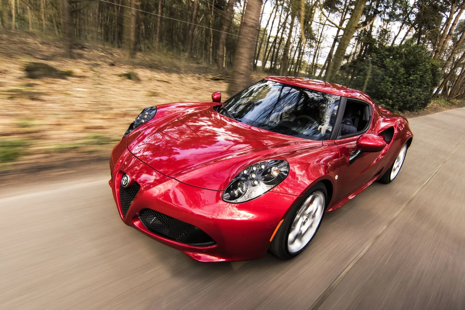 Red exotic sports car in motion