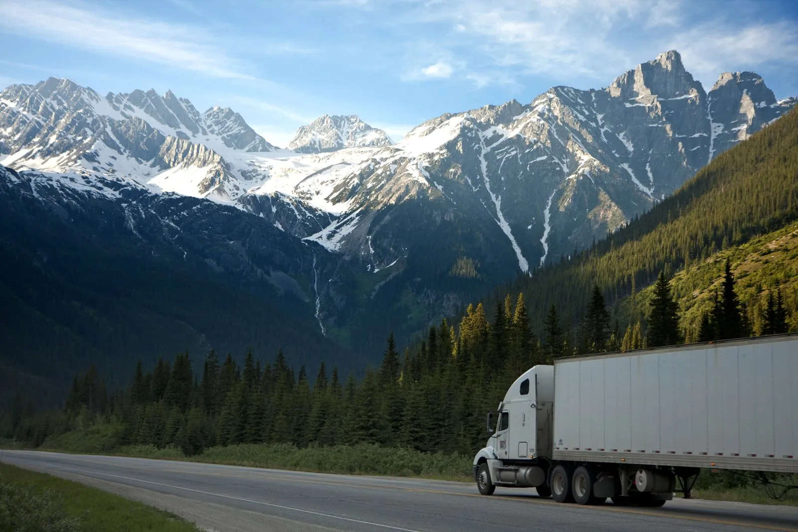 Enclosed trailer hauling vehicles on the highway